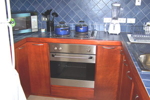 The kitchen has first-class wood, tile, and appliances. 